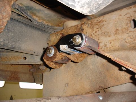 1996 Ford Bronco - New suspension part installed on a heavily rusted vehicle frame.