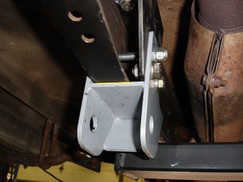 1996 Ford Bronco - Close-up view of custom bracketry attached to the undercarriage of a vehicle.