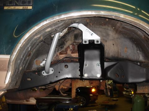 1996 Ford Bronco - Aftermarket suspension components installed in the rear wheel well of a 1996 Ford Bronco.