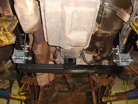 1996 Ford Bronco - New crossmember installed on the underside of a vehicle, connecting to the transmission.