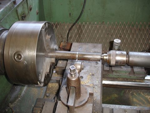 1996 Ford Bronco - A metal rod is held in a lathe chuck and being worked on.