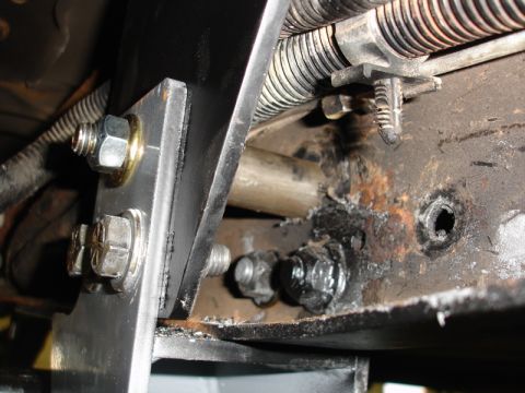 1996 Ford Bronco - Detail of vehicle frame components, including bolts and suspension elements.