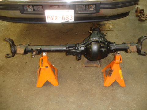 1996 Ford Bronco - Rear axle assembly removed from vehicle and supported on jack stands.