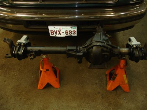 1996 Ford Bronco - Rear axle assembly from a 1996 Ford Bronco, supported by jack stands.