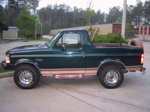 1995 Ford Bronco - This green Ford Bronco, likely from the early 1990s, is shown from the side with its top removed.