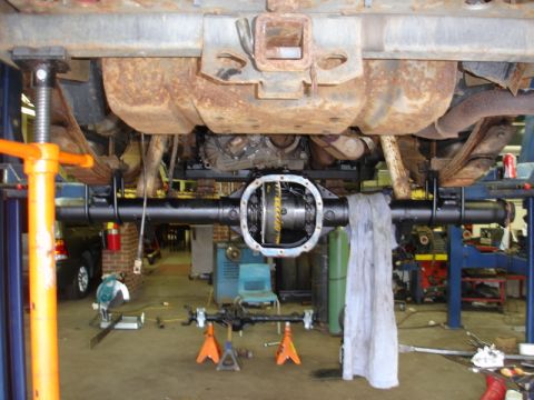 1996 Ford Bronco - The rear axle differential is exposed and appears to be undergoing maintenance or repair in a workshop setting.