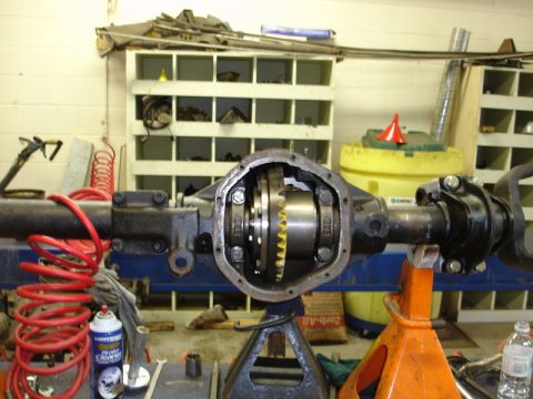 1996 Ford Bronco - Close-up of an open differential axle assembly in a workshop setting.