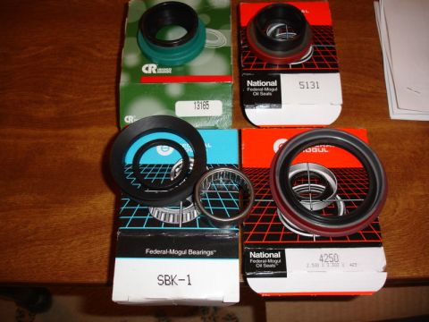 1996 Ford Bronco - Automotive oil seals and bearings from National and CR brands are laid out on a table.
