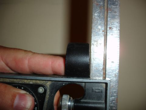 1996 Ford Bronco - A close-up shows a finger and a black part being measured against a metal ruler.
