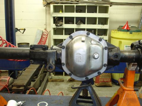 1996 Ford Bronco - A vehicle's rear axle differential assembly is shown supported by jack stands in a workshop.