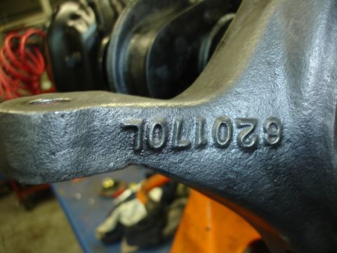 1996 Ford Bronco - Close-up of a cast metal automotive part showing stamped identification numbers.