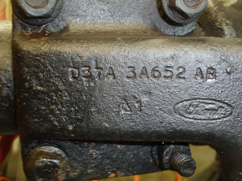 Close-up of black Ford part with casting numbers D3TA 3A652 AB and Ford logo