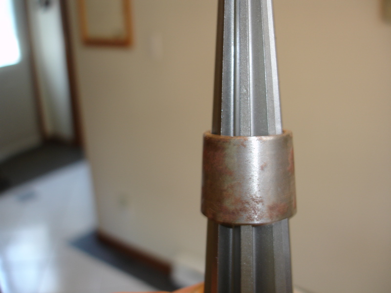 Metal tool with a rusty ring around its tapered shaft
