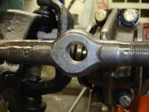 1996 Ford Bronco - A close-up view of a metal steering linkage component, likely part of a vehicle's suspension system.