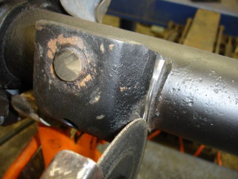 1996 Ford Bronco - A metal part is being cut with a grinder, showing sparks and metal shavings.