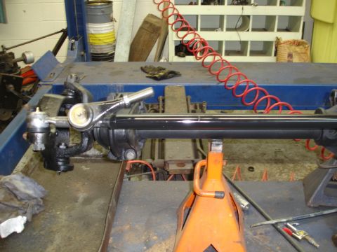 1996 Ford Bronco - Vehicle steering and suspension components are shown on a lift in a workshop setting.