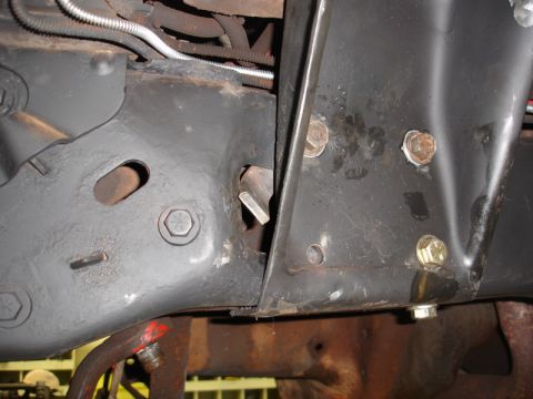 1996 Ford Bronco - Detail shot of the undercarriage, focusing on the frame and suspension mounting points.