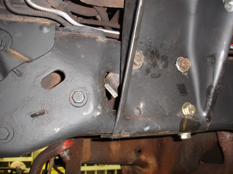 close-up of vehicle frame with bolts and wiring