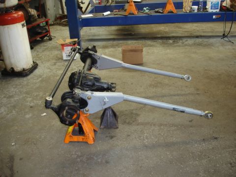 1996 Ford Bronco - Two differential assemblies with control arms are shown on jack stands in a workshop setting.