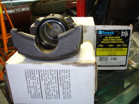 1996 Ford Bronco - A brake caliper sits on boxes, with a Fenco disc brake caliper box nearby.