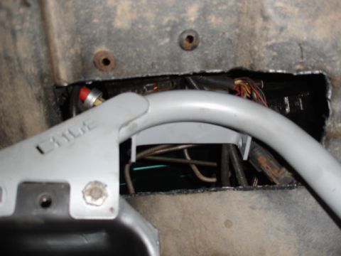 1996 Ford Bronco - Close-up of interior wiring and a roll cage bracket, with some text visible on the bracket.
