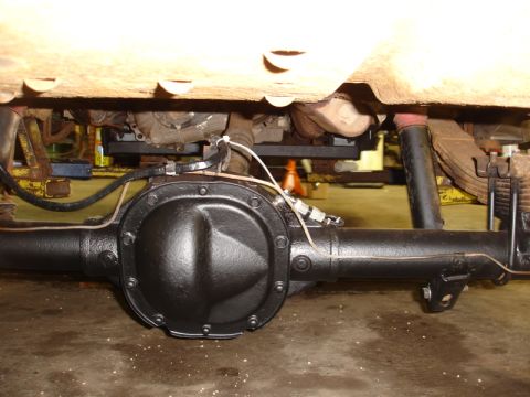 1996 Ford Bronco - Underside view of a vehicle's rear axle, leaf springs, and shock absorber.