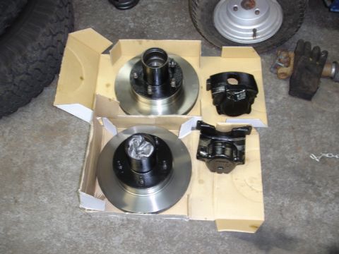 1996 Ford Bronco - Unboxed brake components, including rotors and calipers, are ready for installation.