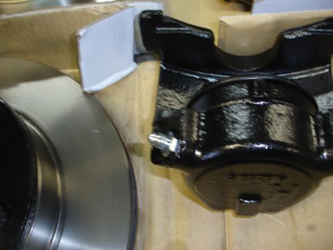 1996 Ford Bronco - A new brake caliper and rotor are shown, ready for installation.