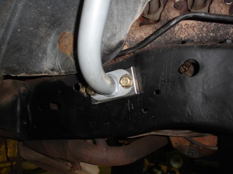 1996 Ford Bronco - Close-up of an aftermarket anti-roll bar mounting bracket attached to the vehicle's frame.