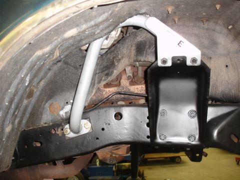 1996 Ford Bronco - Close-up view of an aftermarket sway bar and mounting bracket attached to the vehicle's frame.