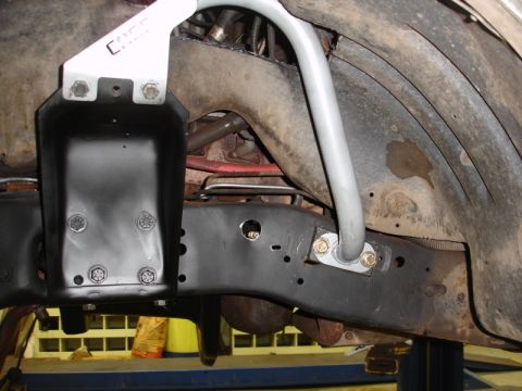 1996 Ford Bronco - Aftermarket sway bar installation in progress, focusing on the frame and suspension components.