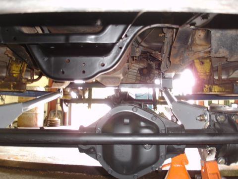 1996 Ford Bronco - Close-up view of the underside of a vehicle, highlighting the rear axle and drivetrain components.