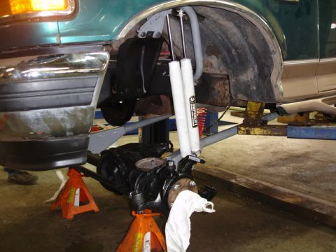 1996 Ford Bronco - Front suspension and fender well of a 1996 Ford Bronco undergoing repairs.