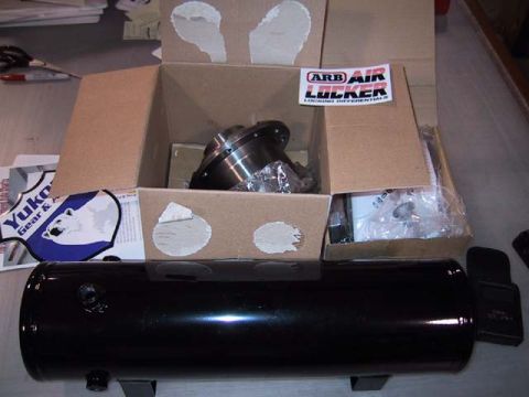 1995 Ford Bronco - Unboxed ARB Air Locker and a black air tank are laid out on a surface.