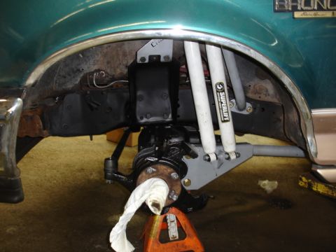 1996 Ford Bronco - Close-up of the front suspension and wheel hub assembly on a 1996 Ford Bronco, Superlift shocks.