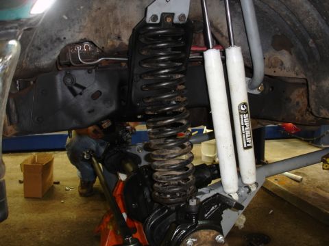 1996 Ford Bronco - Close-up view of vehicle suspension components, including springs and shocks, during a repair or upgrade.