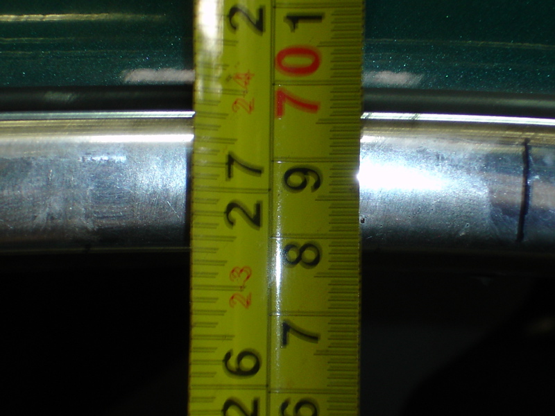 Yellow measuring tape shows 27 inches on a chrome bar