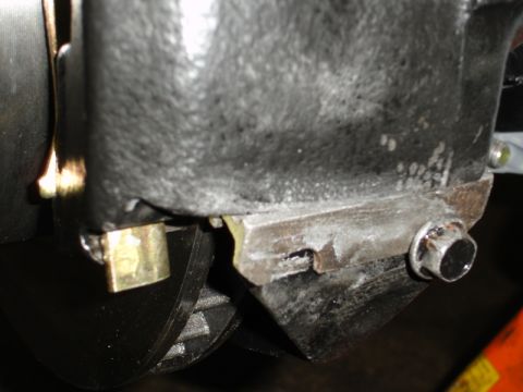 1996 Ford Bronco - A detailed view of an engine part, showing mechanical connections and metal construction.