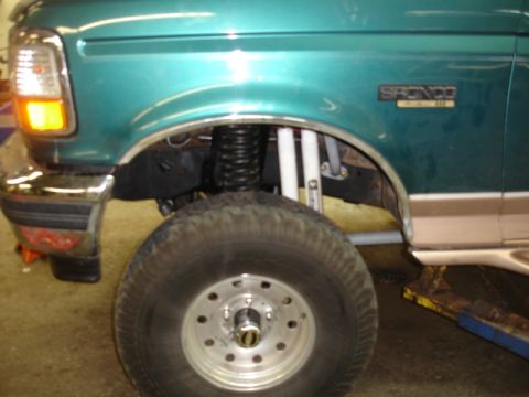 1996 Ford Bronco - Front quarter view of a teal 1996 Ford Bronco, showing its lifted suspension and prominent tire.