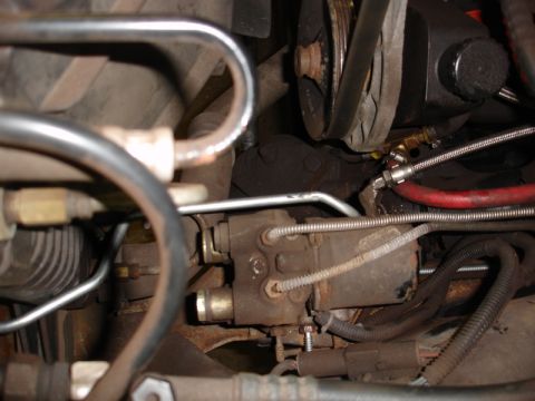 1996 Ford Bronco - A detailed view of various engine components, showing hoses, belts, and mechanical parts.