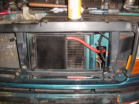 1996 Ford Bronco - Front view of a teal 1992 Ford F-150's radiator and condenser assembly.
