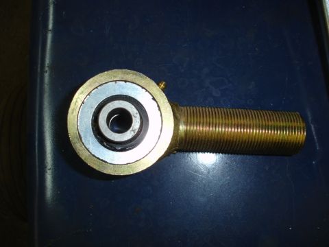 1996 Ford Bronco - A close-up view of a rod end bearing with a threaded shaft.