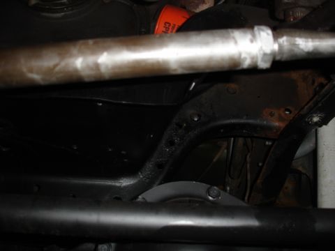 1996 Ford Bronco - Undercarriage view with suspension parts and an orange oil filter. Year is not discernible.