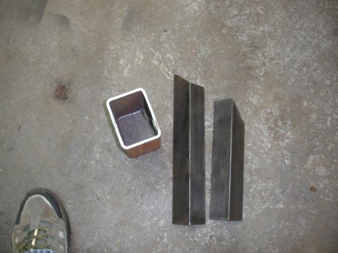 1996 Ford Bronco - Various car parts are laid out on a concrete surface, suggesting a disassembly or repair process.