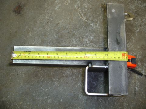 1996 Ford Bronco - A metal component is being measured using a tape measure and a carpenter's square.