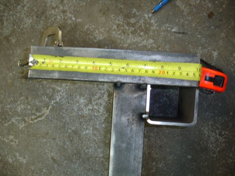 1996 Ford Bronco - A tape measure is shown extended over a metal bracket, possibly for a measurement or repair.