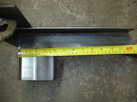 1996 Ford Bronco - A close-up view shows a metal part being measured with a tape measure.