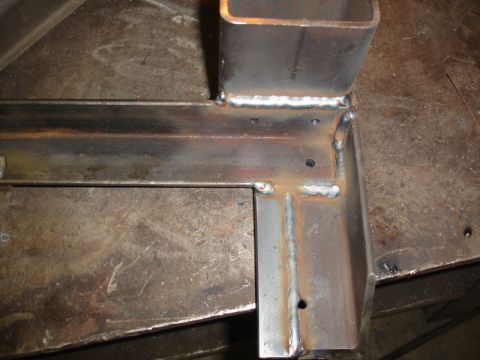 1996 Ford Bronco - Close-up view of a fabricated metal component, showing the results of welding and drilling.