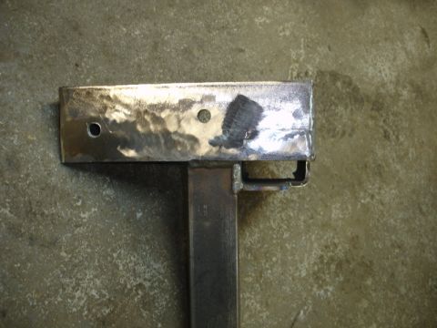 1996 Ford Bronco - A metal bracket is shown against a concrete background.