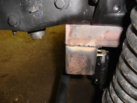1996 Ford Bronco - A custom metal bracket is welded onto the vehicle's frame, showing signs of modification.